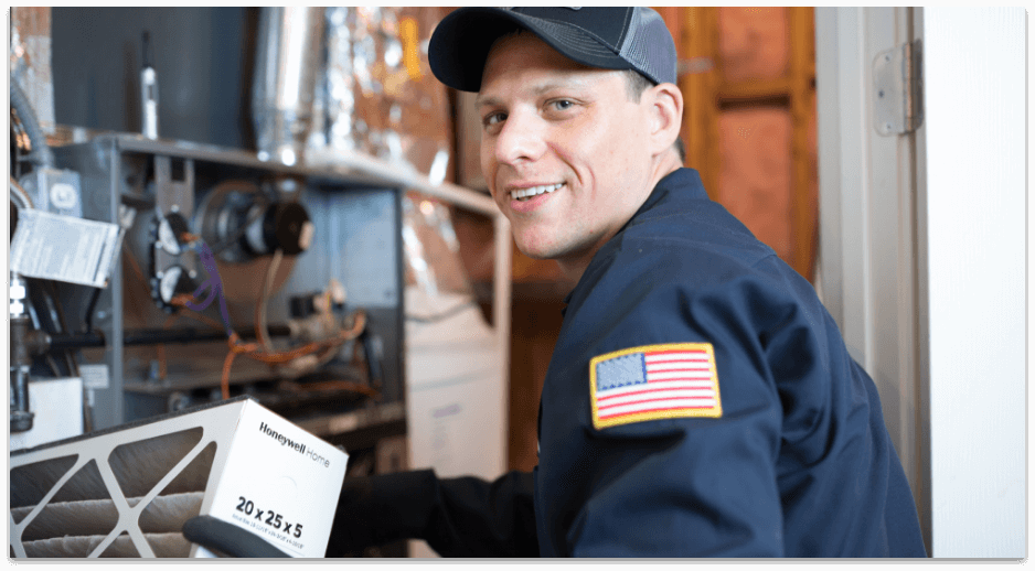 Hvac technician holding furnace filter