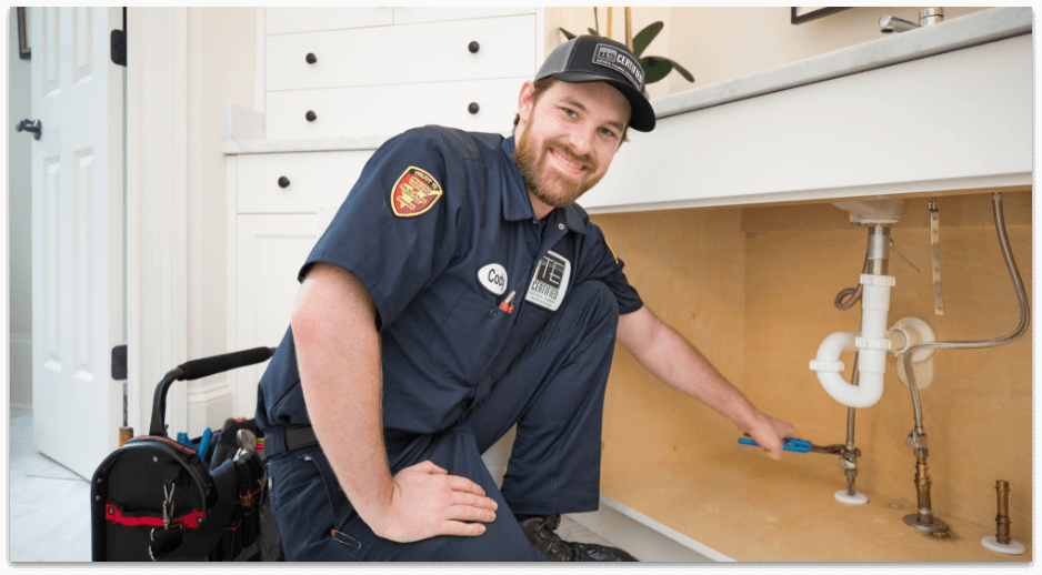 Te certified technician performing plumbing repair