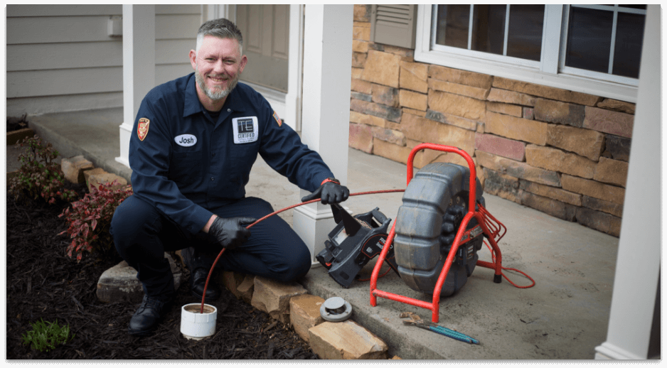 Technician performing main sewer line camera inspection